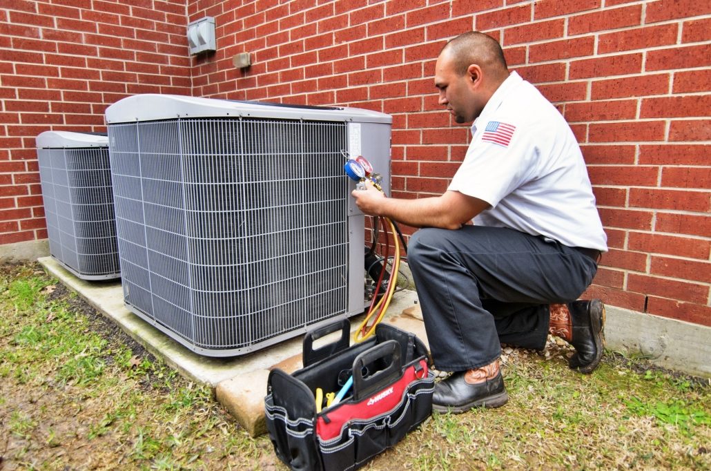 HVAC technician performing AC maintenance services