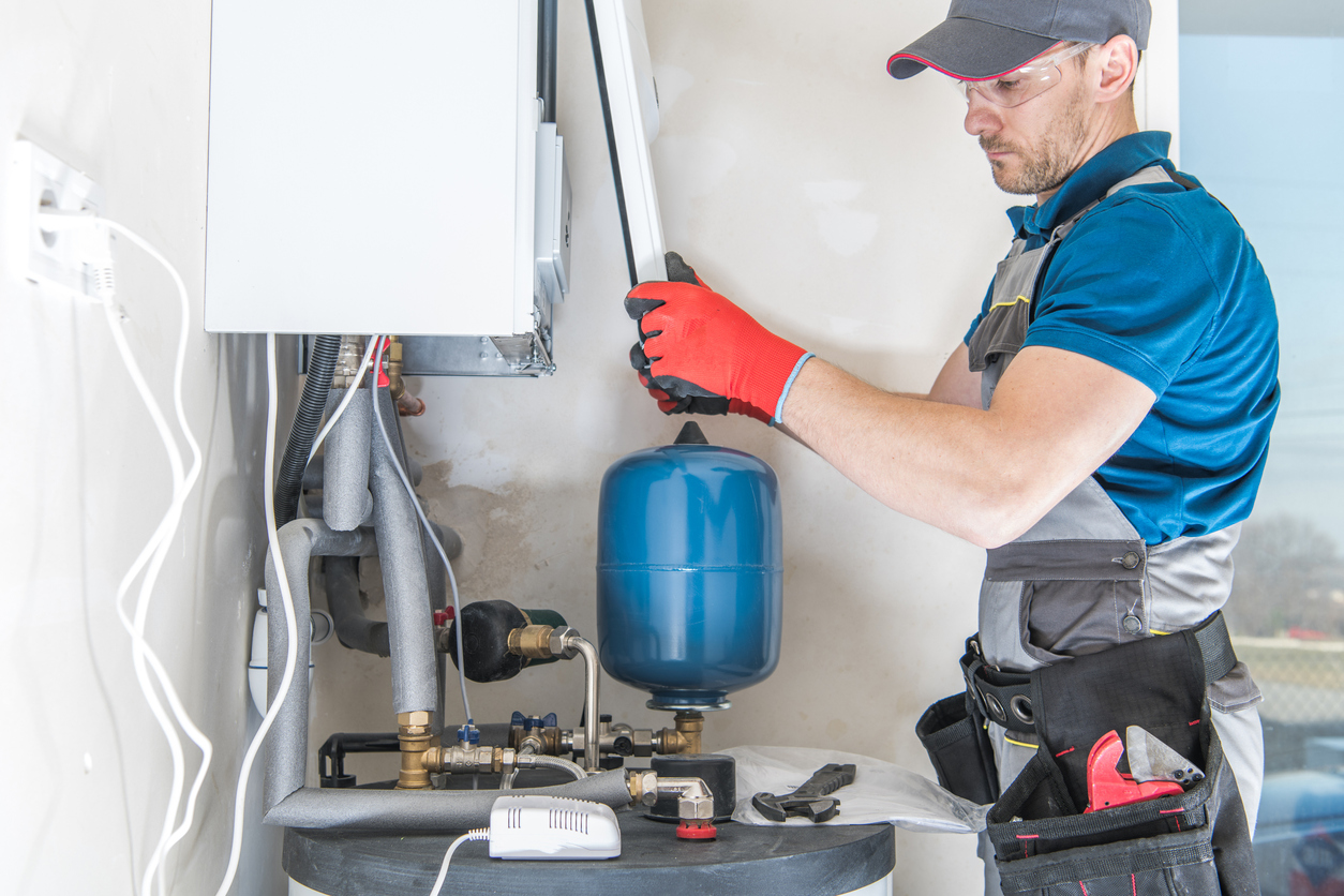 HVAC technician installing a gas heater in a Dearborn home