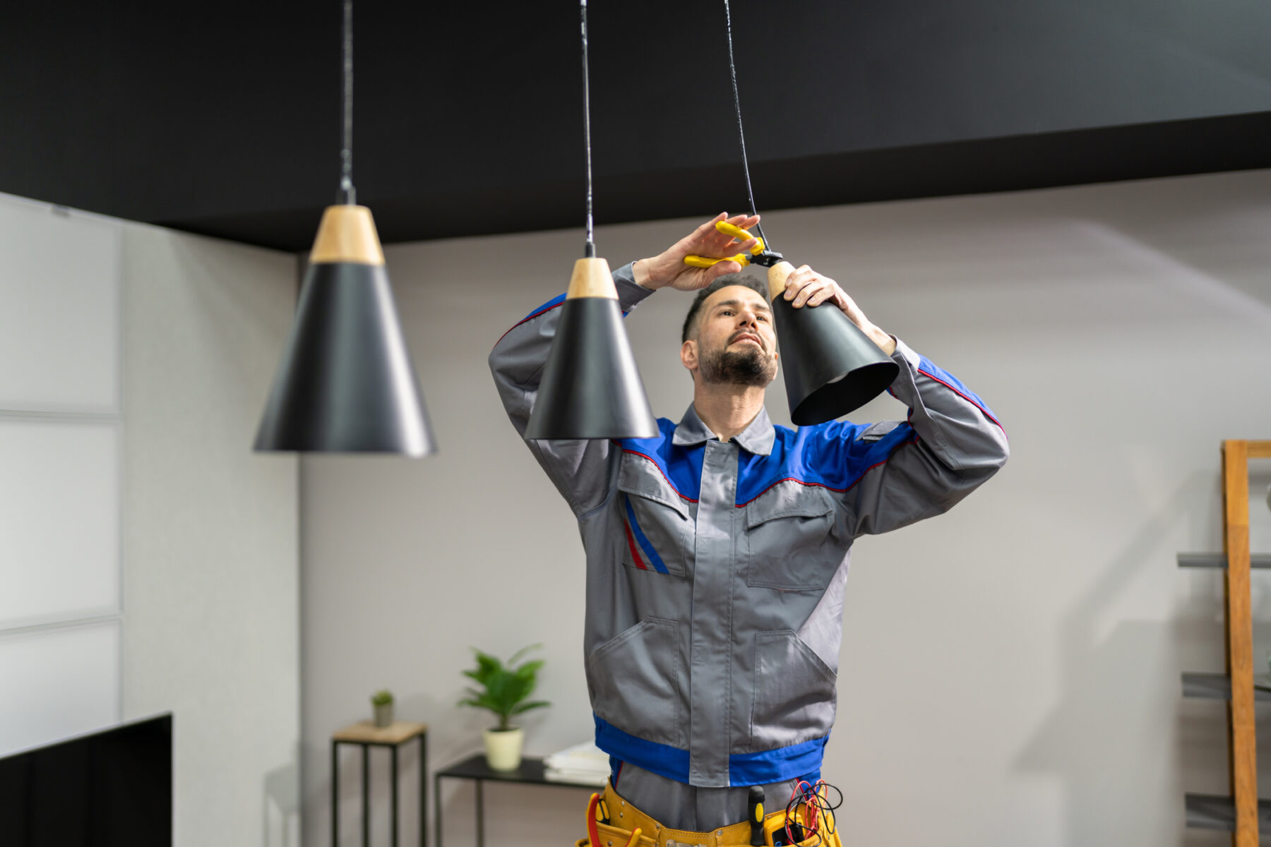 Electrician installing light fixtures in a Michigan home