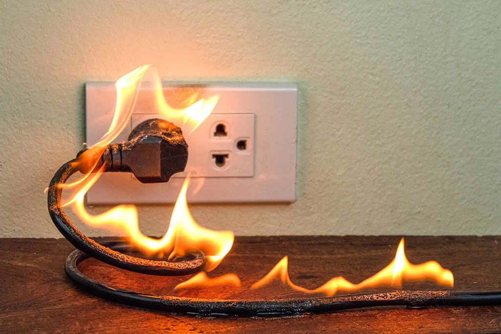 Outlet with a plug on fire