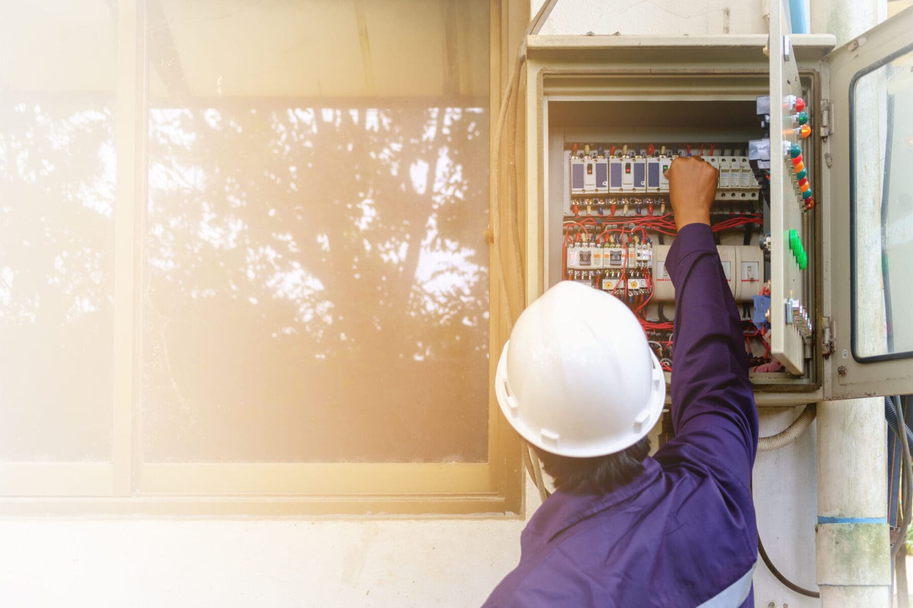 Electrician inspecting the electrical panel of a Michigan home