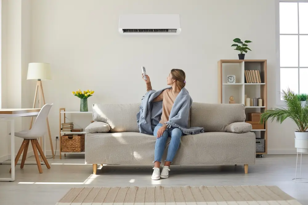 woman adjusting ac temperature for summer