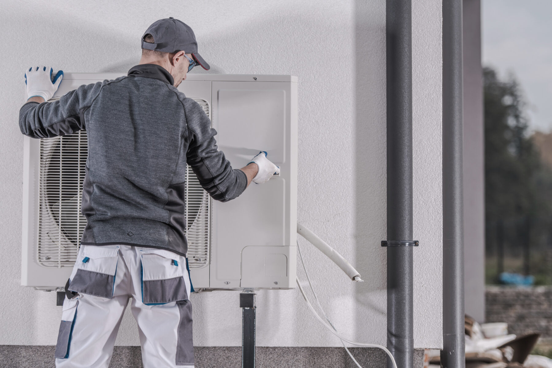 HVAC technician repairing a home’s heat pump