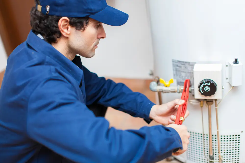 plumber performing a water heater repair