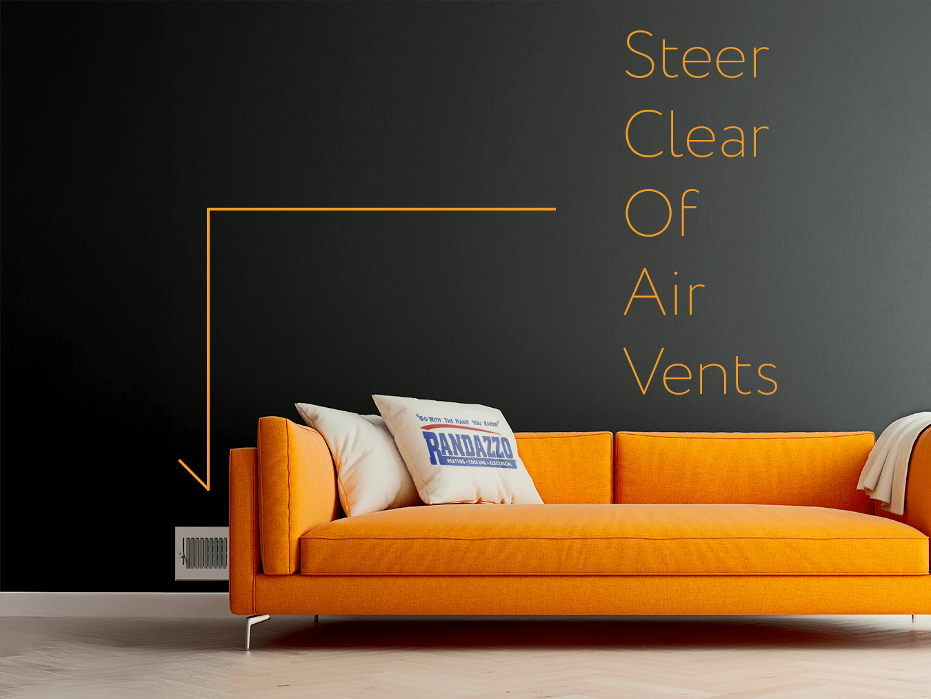 An orange couch blocking an air vent. The couch has a randazzo pillow and words on the wall that says Steer Clear of air vents