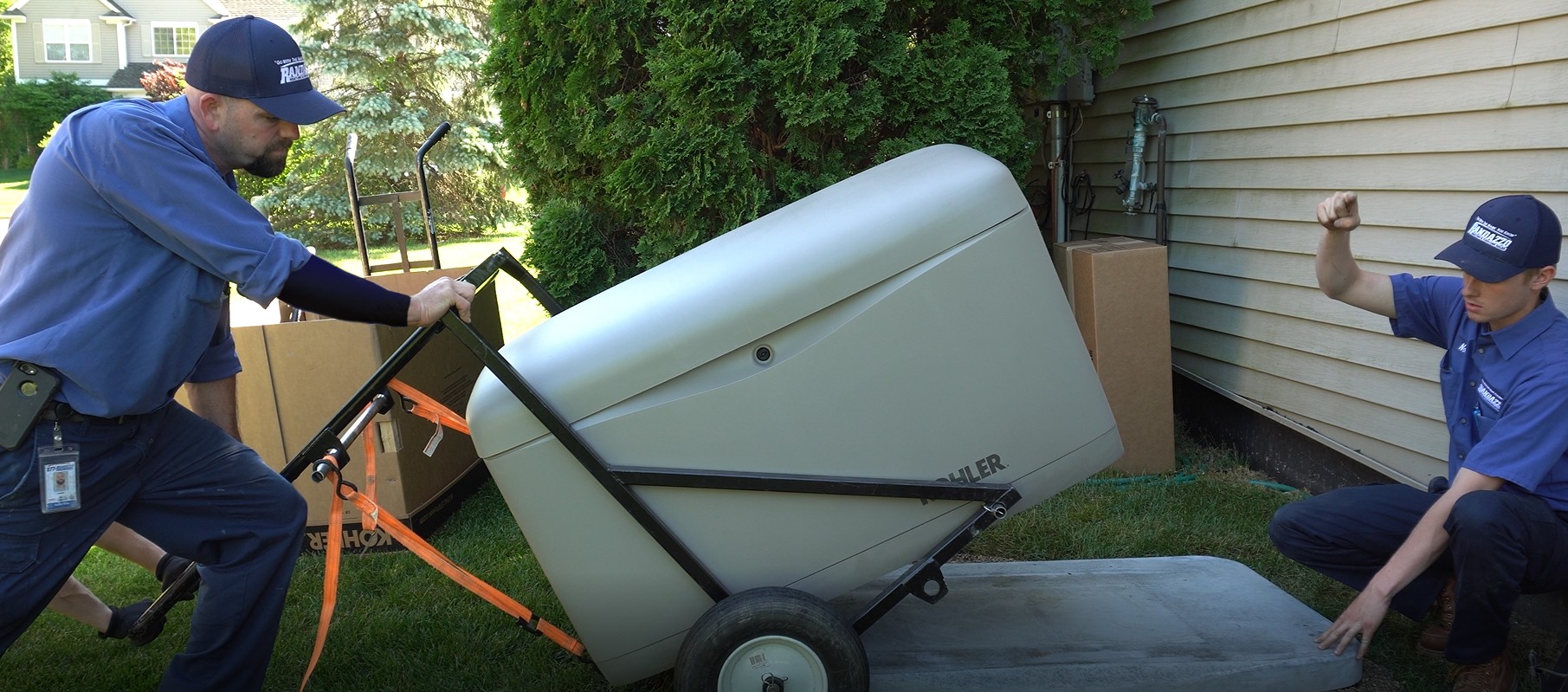 Two Randazzo techs Installing a Kohler whole-home generator in customers yard.